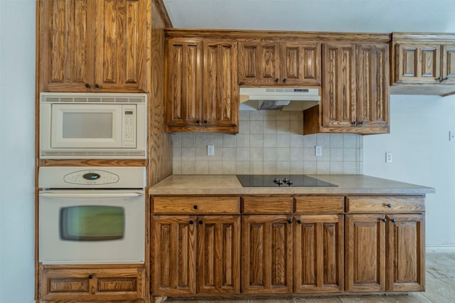 kitchen with white appliances and backsplash