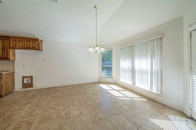 unfurnished dining area with light tile patterned flooring, vaulted ceiling, and a notable chandelier