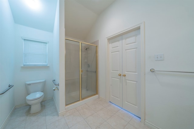 bathroom featuring tile patterned flooring, lofted ceiling, walk in shower, and toilet