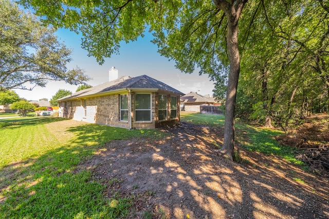 rear view of property with a yard