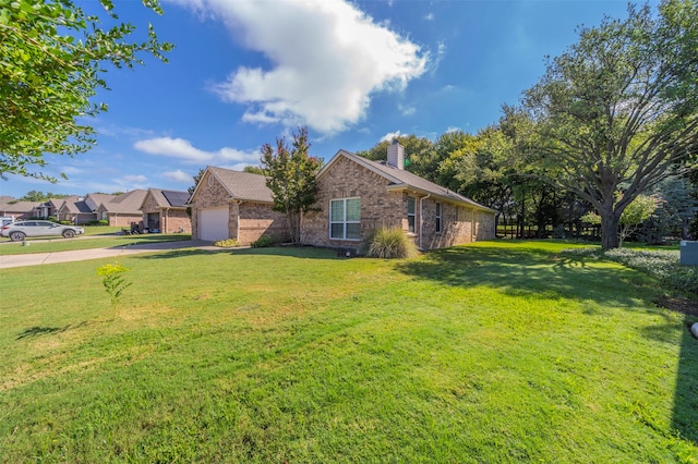 ranch-style house featuring a front yard and a garage