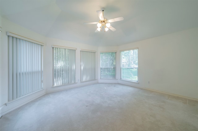 carpeted spare room with lofted ceiling and ceiling fan