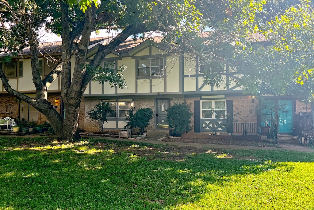 english style home with a front lawn