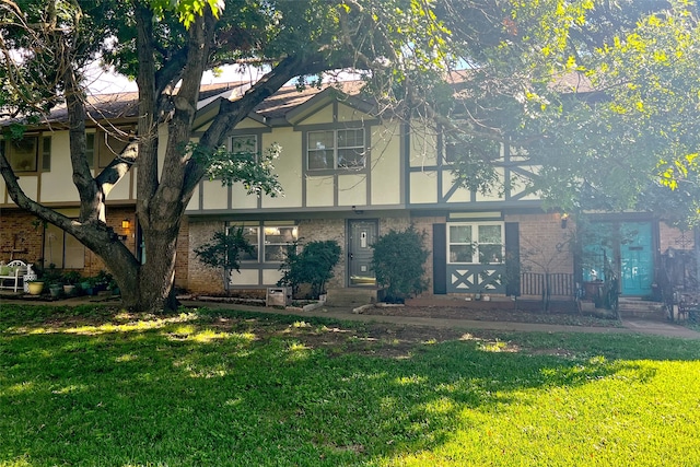 english style home with a front lawn