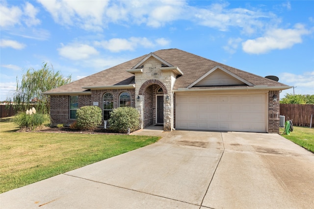 ranch-style house with a garage and a front lawn