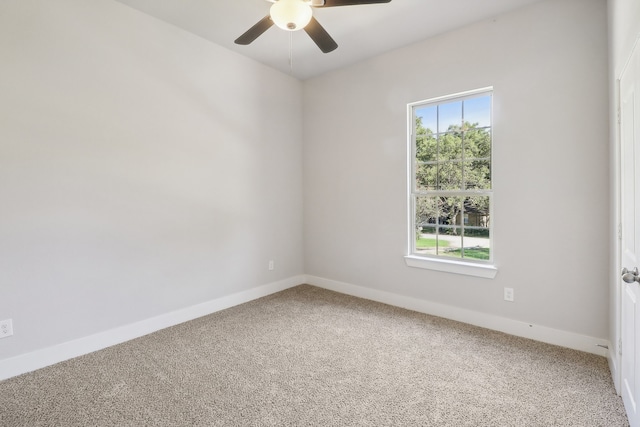 carpeted spare room with a wealth of natural light and ceiling fan