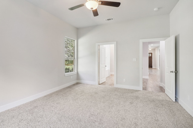 unfurnished bedroom featuring ceiling fan and light carpet