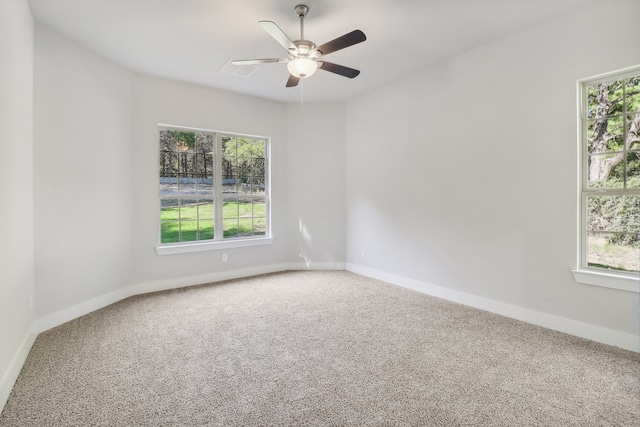 carpeted spare room with ceiling fan