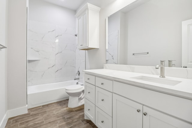 full bathroom with vanity, tiled shower / bath combo, and toilet