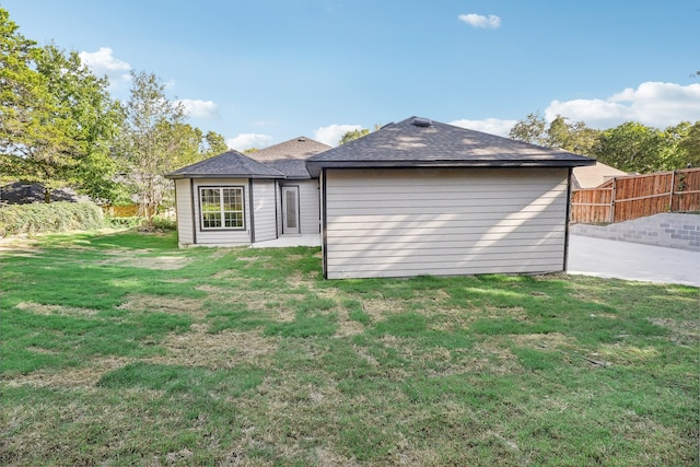 rear view of property with a patio and a yard