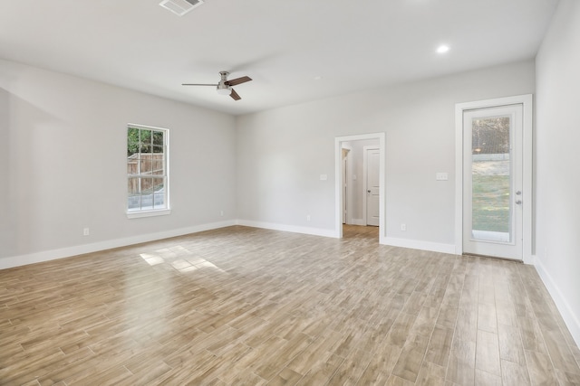 spare room with light wood-type flooring and ceiling fan