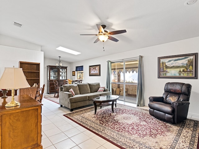 living room with vaulted ceiling, ceiling fan, and light tile patterned floors