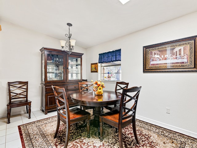 dining room with light tile patterned flooring and a chandelier