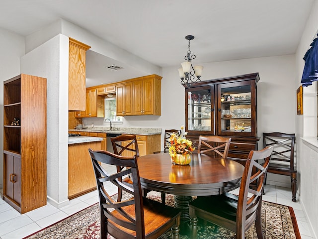 tiled dining area with sink and a notable chandelier