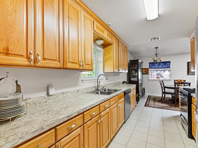 kitchen with black range with gas stovetop, pendant lighting, stainless steel dishwasher, sink, and a notable chandelier