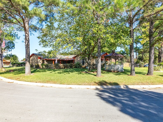 view of front of house featuring a front yard and a gazebo