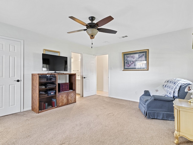 sitting room with ceiling fan and carpet