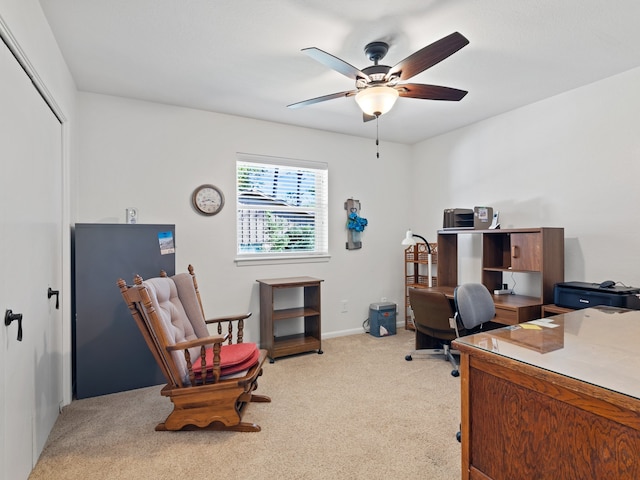 office space with ceiling fan and light carpet