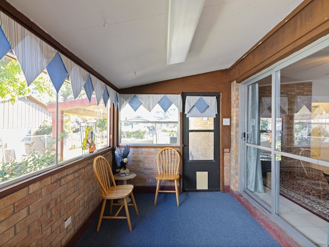 sunroom featuring plenty of natural light and vaulted ceiling