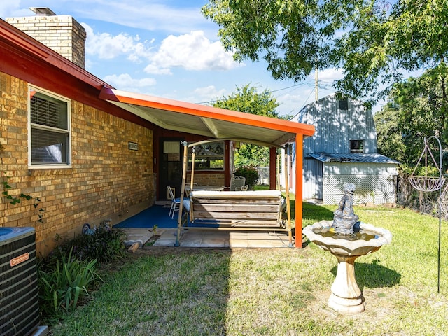 view of yard with a patio and central AC