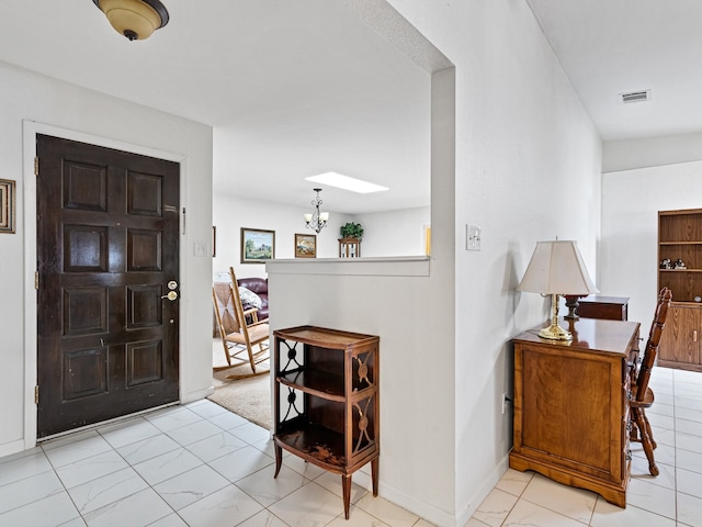 entryway featuring a notable chandelier