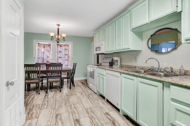 kitchen with a notable chandelier, white appliances, decorative light fixtures, green cabinets, and sink