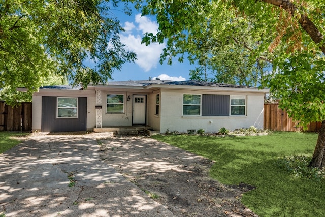 ranch-style house with a front lawn