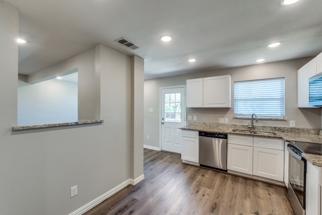 kitchen with black range with electric stovetop, light wood-type flooring, white cabinetry, and stainless steel dishwasher