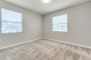 unfurnished room featuring light colored carpet