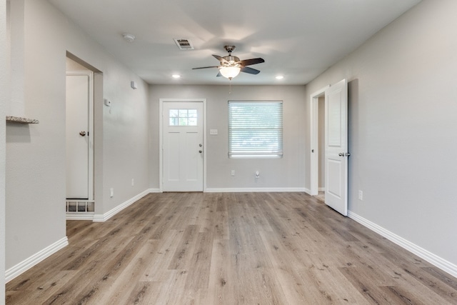 foyer with ceiling fan and light hardwood / wood-style flooring