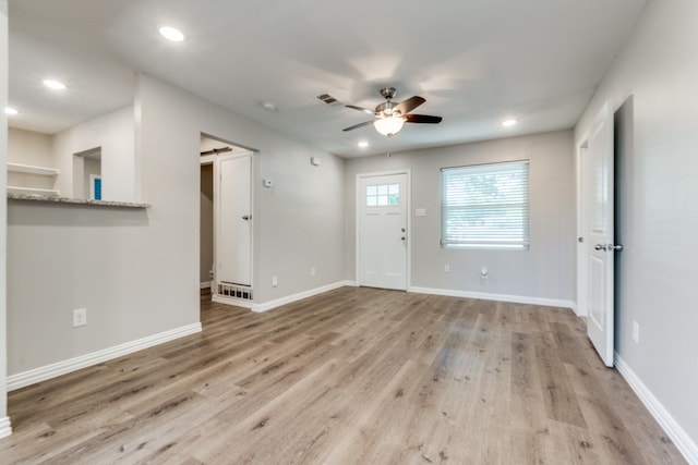 unfurnished living room with ceiling fan and light hardwood / wood-style flooring