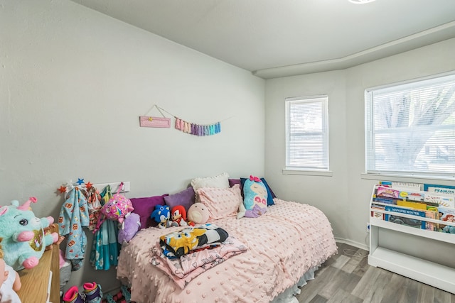 bedroom with hardwood / wood-style floors