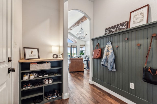 mudroom featuring vaulted ceiling, a notable chandelier, and dark hardwood / wood-style flooring