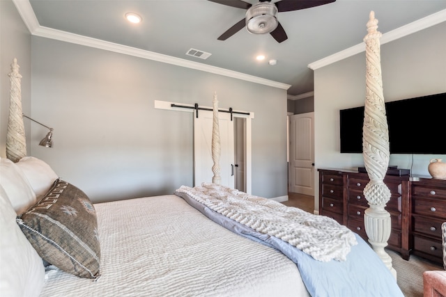 bedroom with ornamental molding, ceiling fan, and a barn door