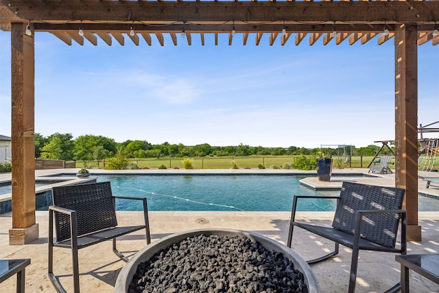 view of pool with a patio area and an outdoor fire pit