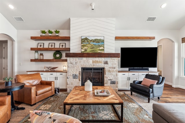 living room with hardwood / wood-style floors and a fireplace