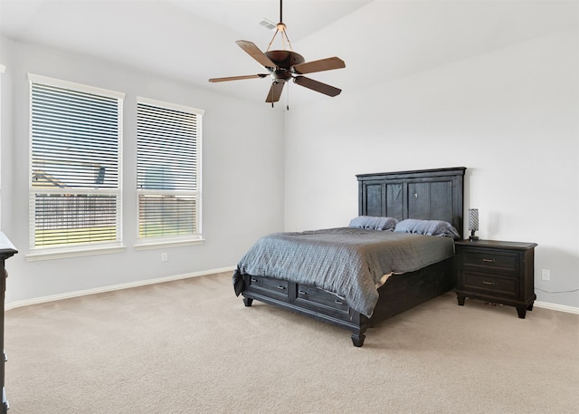 bedroom featuring light carpet, vaulted ceiling, and ceiling fan