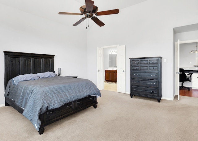 carpeted bedroom featuring connected bathroom, ceiling fan, and high vaulted ceiling