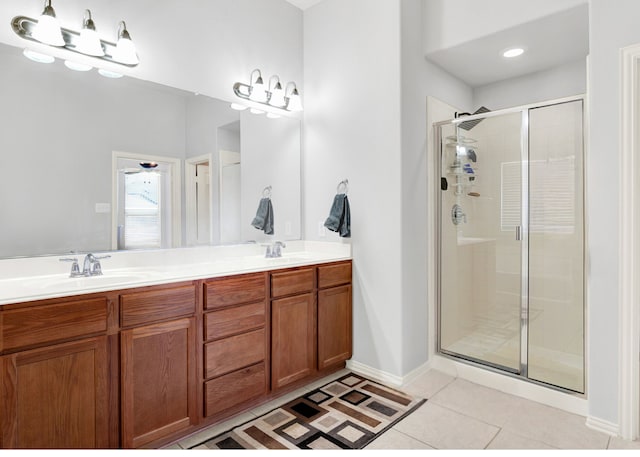 bathroom with tile patterned flooring, walk in shower, and vanity