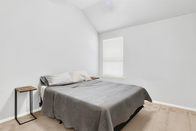 carpeted bedroom with lofted ceiling