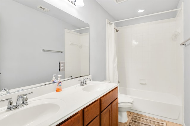 full bathroom with shower / bath combo, vanity, toilet, and tile patterned floors