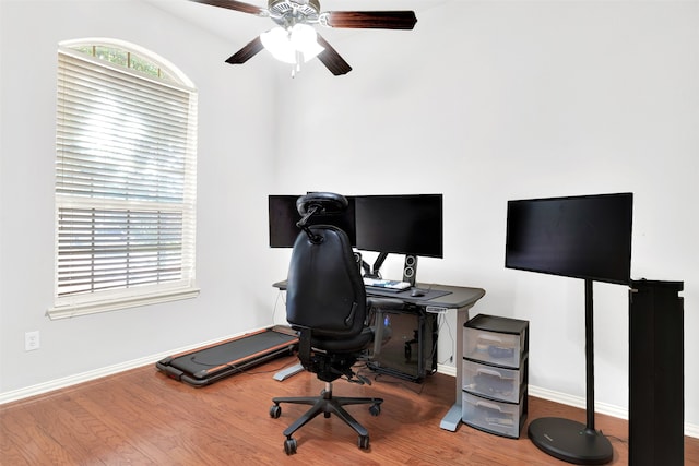 home office with wood-type flooring and ceiling fan