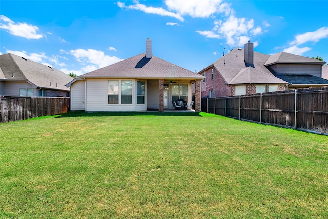 back of house with a lawn