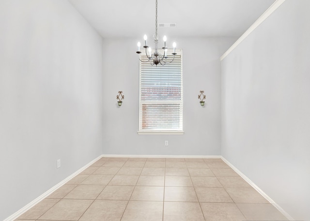 tiled empty room with a chandelier