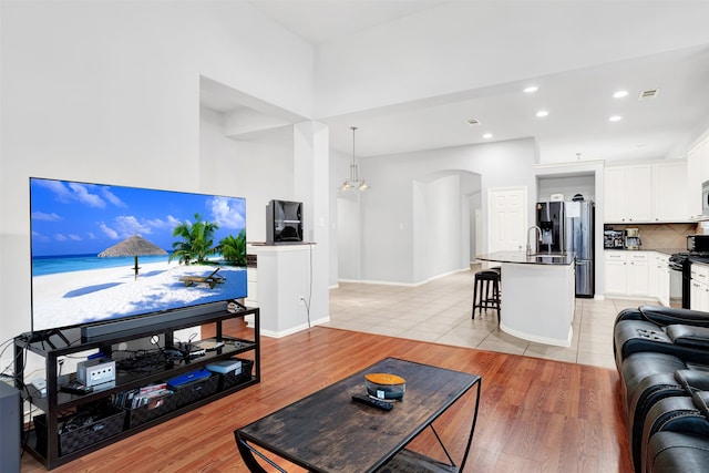 living room featuring light wood-type flooring and sink