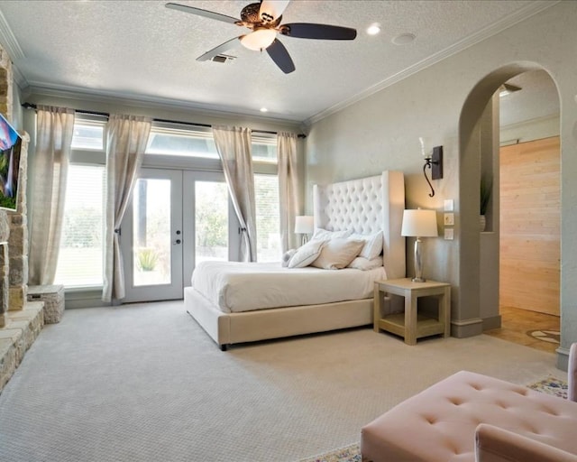 bedroom featuring ceiling fan, a textured ceiling, access to outside, and wooden walls