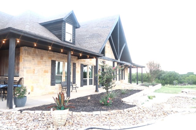 view of side of home featuring a patio area