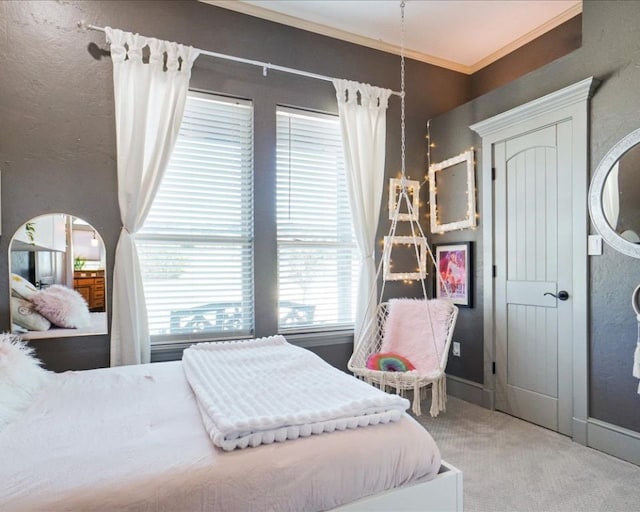 bedroom with ornamental molding and carpet flooring