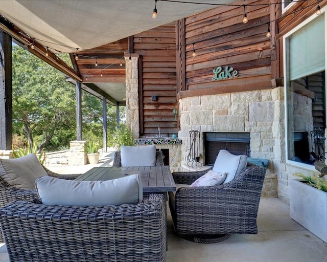 view of patio featuring an outdoor living space with a fireplace