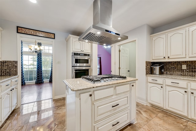 kitchen featuring island range hood, appliances with stainless steel finishes, tasteful backsplash, and a kitchen island